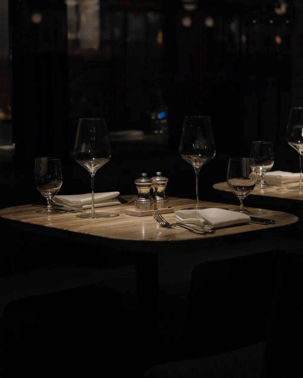 Una mesa puesta con copas, lista para el servicio.