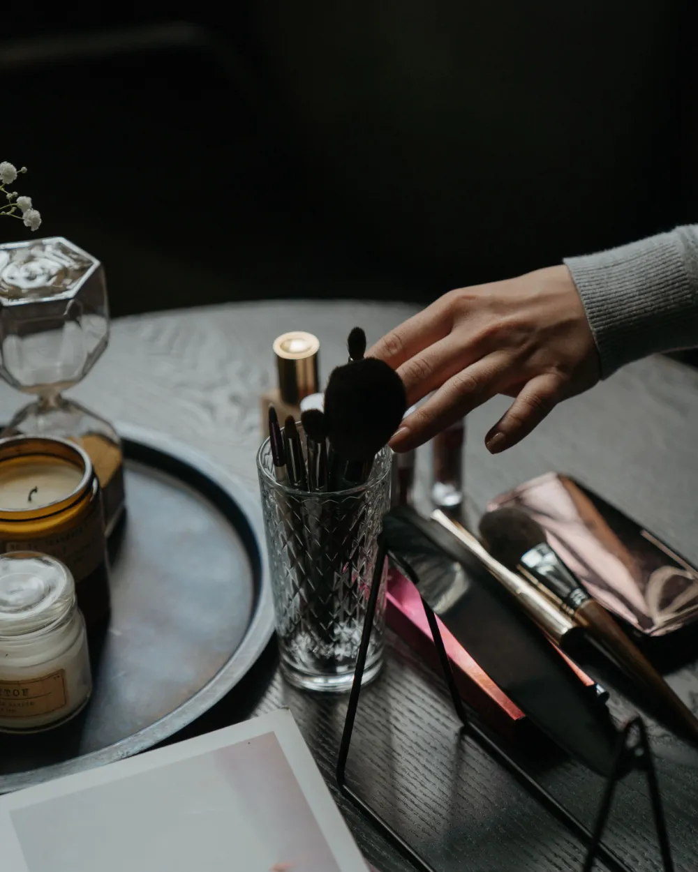 Productos y brochas de maquillaje en el tocador.